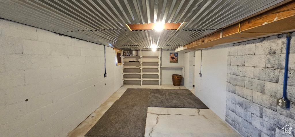 Unfinished basement with concrete block wall