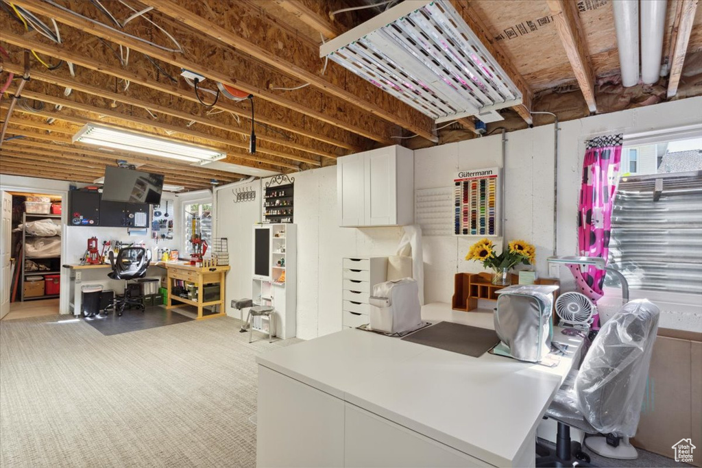 Below grade area featuring carpet flooring and a healthy amount of sunlight