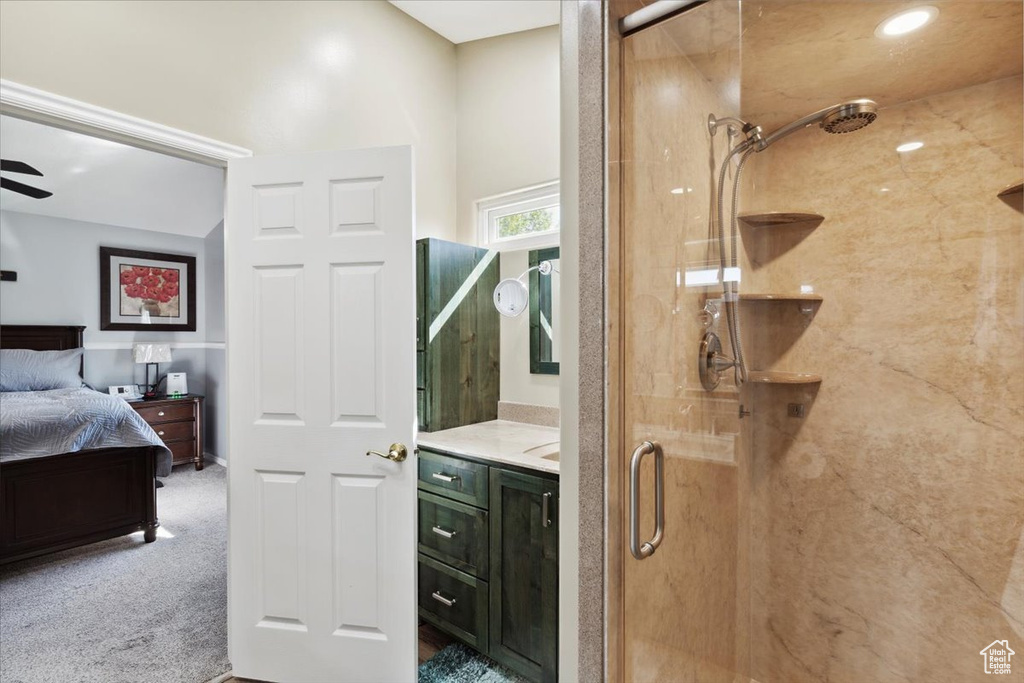 Bathroom featuring ensuite bath, vanity, and a shower stall