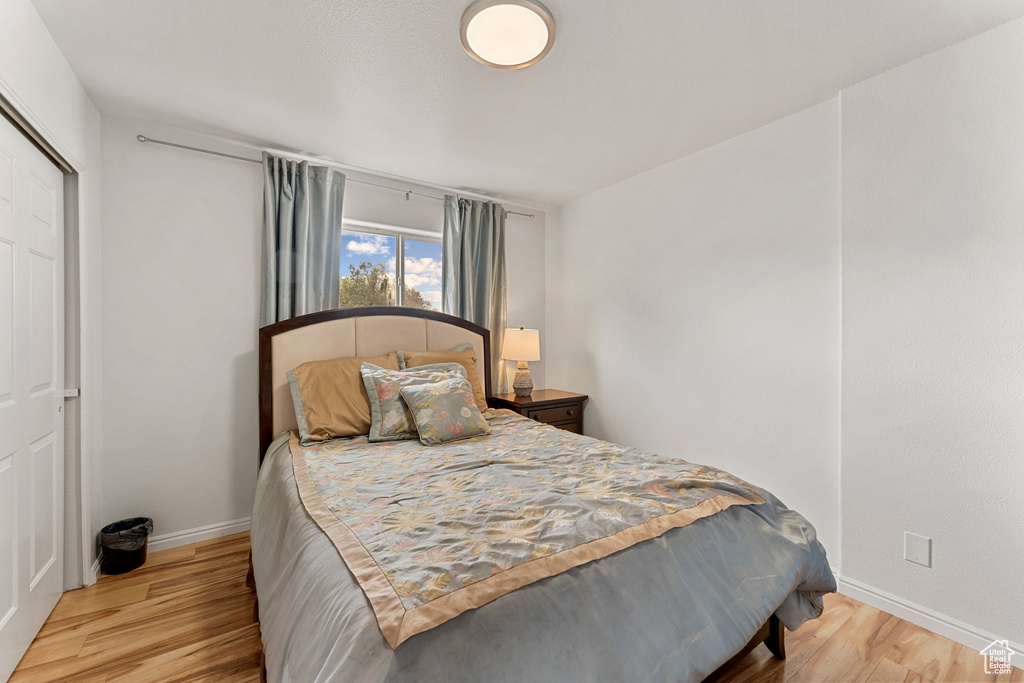 Bedroom with baseboards and wood finished floors