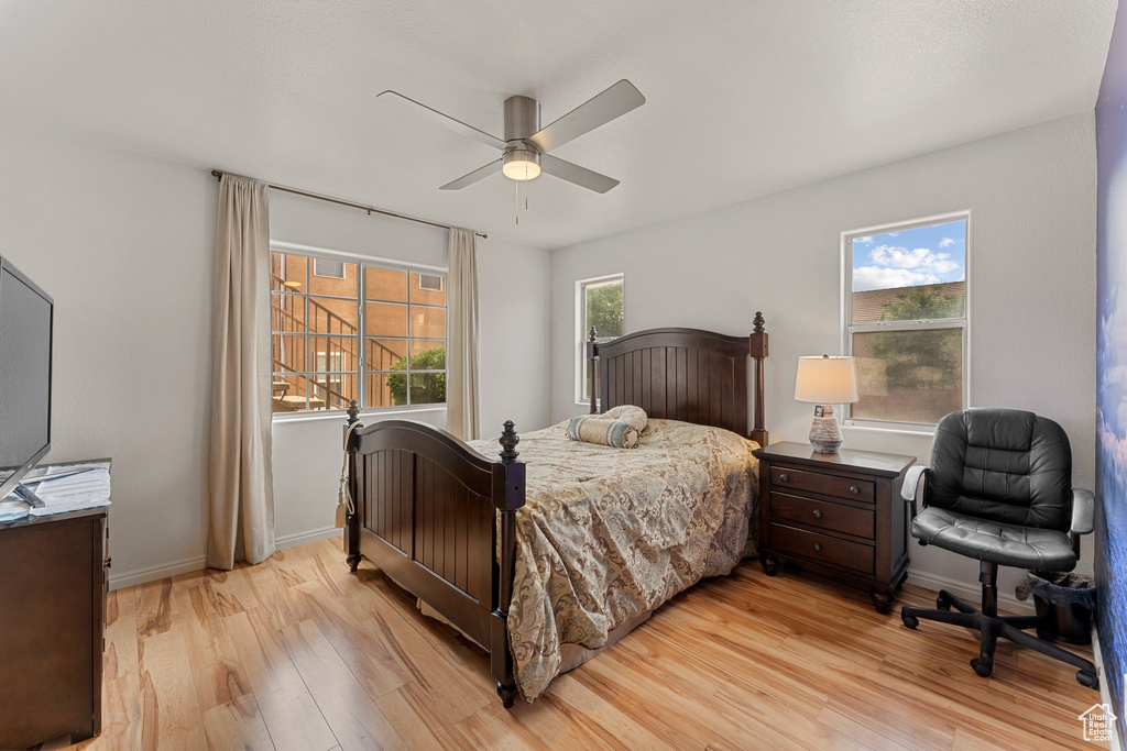 Bedroom with baseboards, a ceiling fan, and light wood finished floors