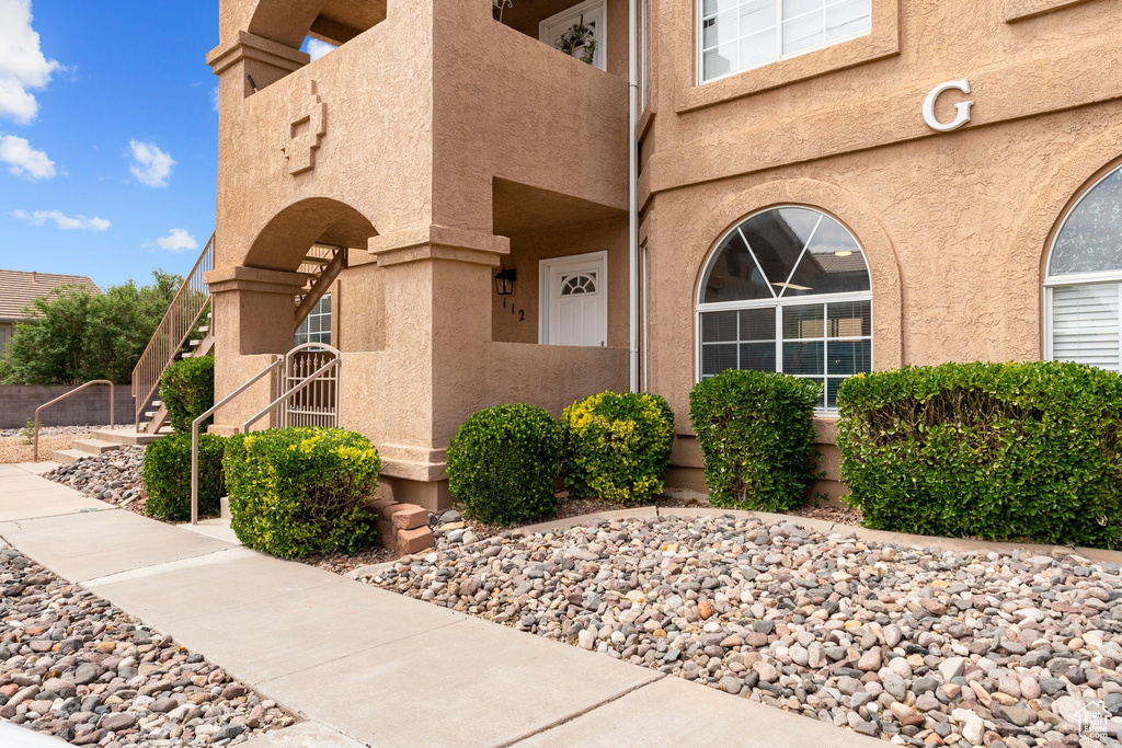 Entrance to property featuring stucco siding