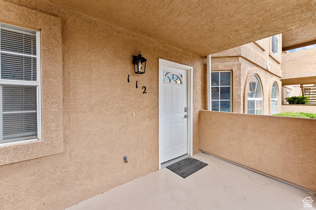 Property entrance featuring stucco siding