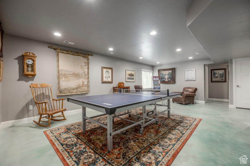 Recreation room featuring baseboards, recessed lighting, visible vents, and finished concrete floors