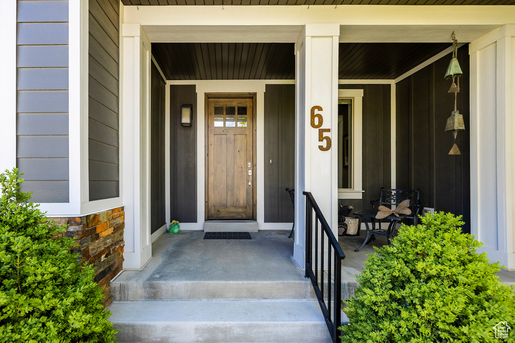 Entrance to property featuring board and batten siding and a porch