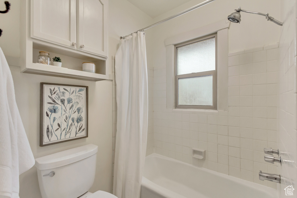 Full bath featuring toilet and shower / bath combo