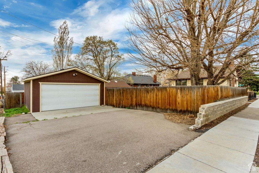 Detached garage featuring fence