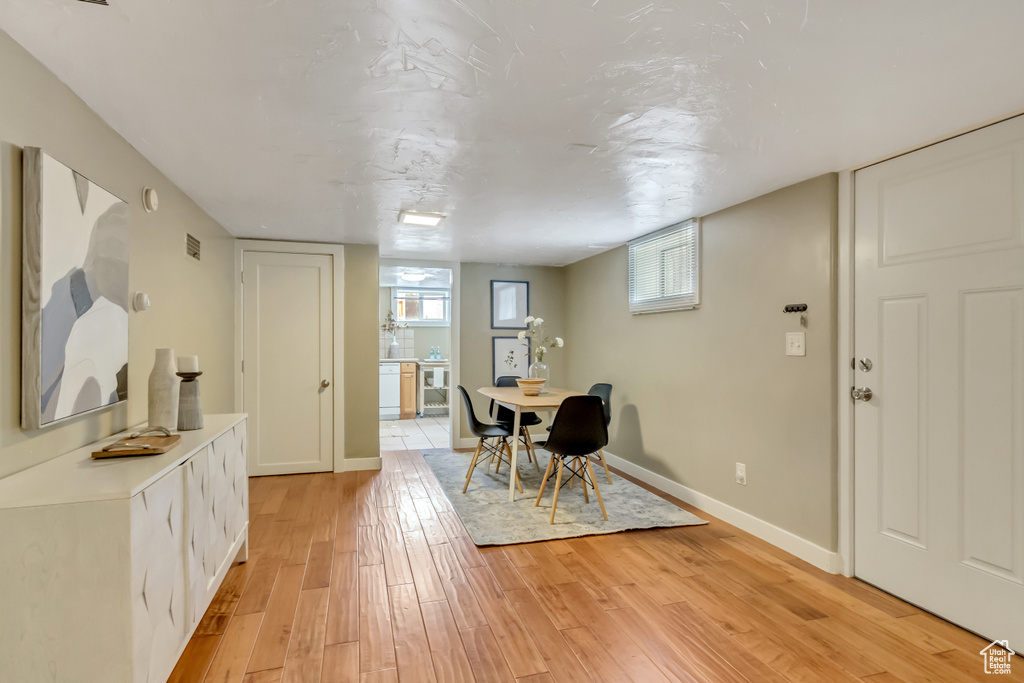 Dining room with plenty of natural light, visible vents, light wood-style flooring, and baseboards