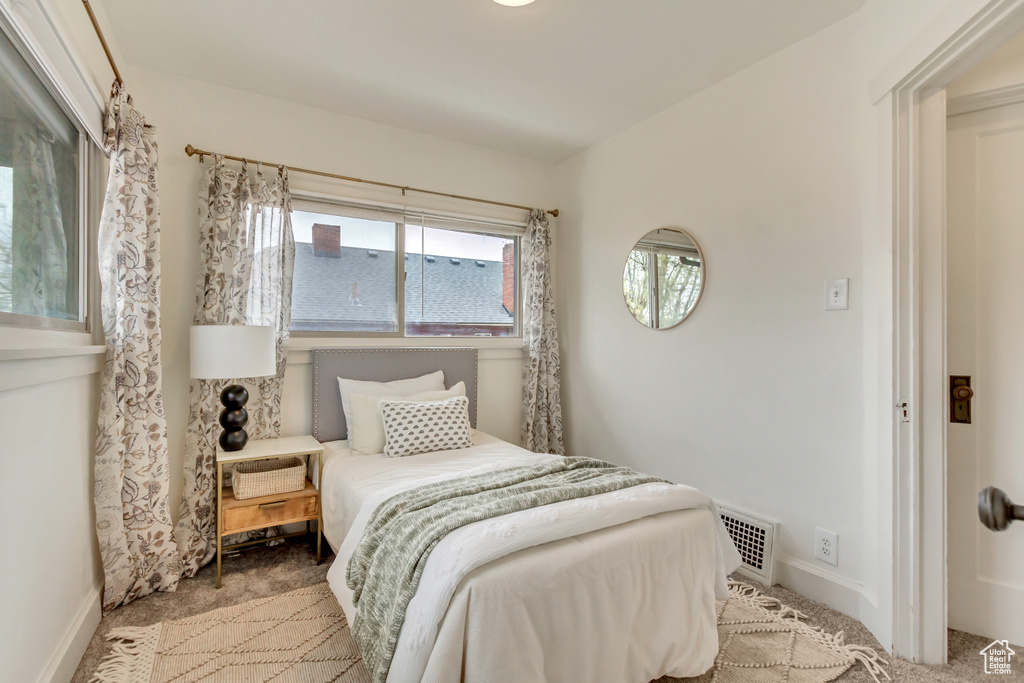 Bedroom featuring carpet flooring, baseboards, and visible vents