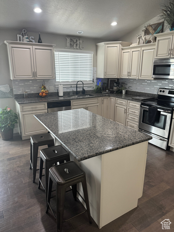 Kitchen with a sink, recessed lighting, decorative backsplash, and appliances with stainless steel finishes