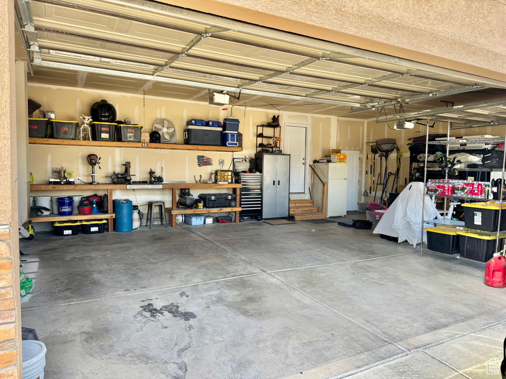 Garage featuring freestanding refrigerator
