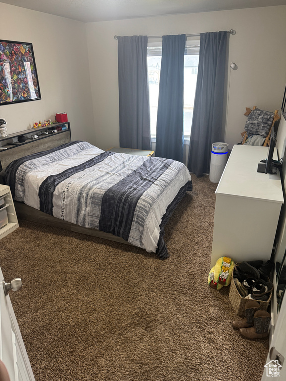 Bedroom featuring dark carpet