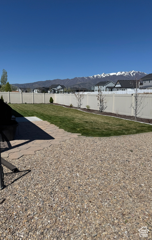 View of yard featuring fence and a mountain view