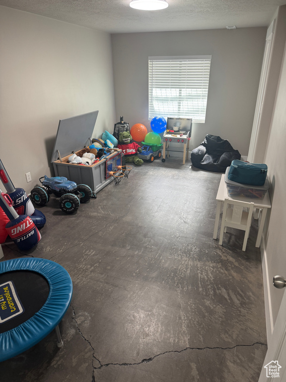 Playroom with a textured ceiling