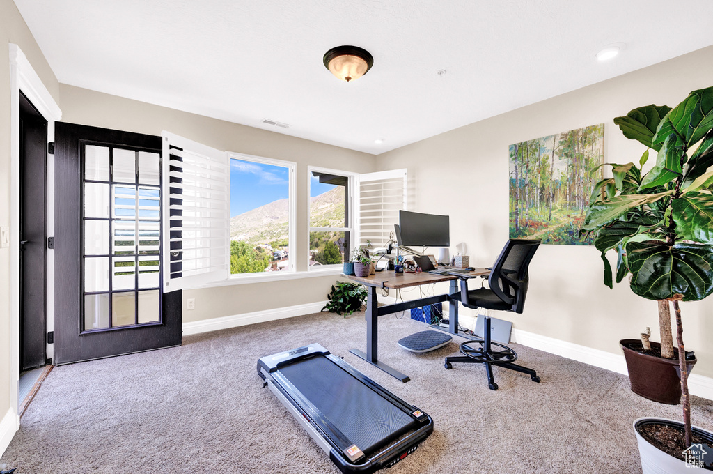 Carpeted office with visible vents and baseboards