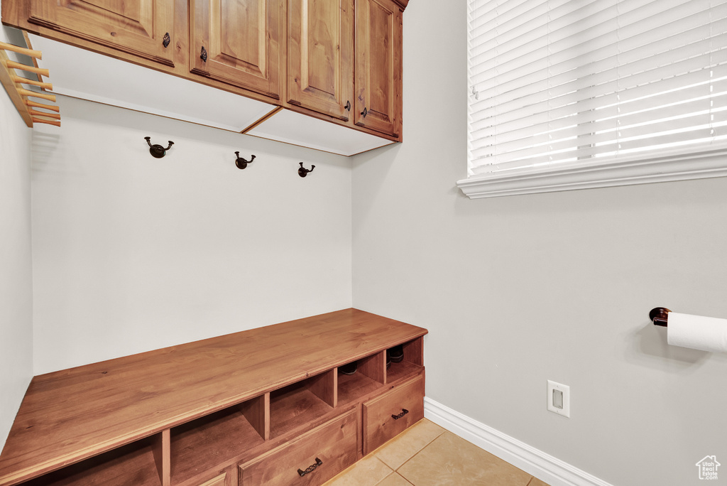 Mudroom with light tile patterned flooring and baseboards