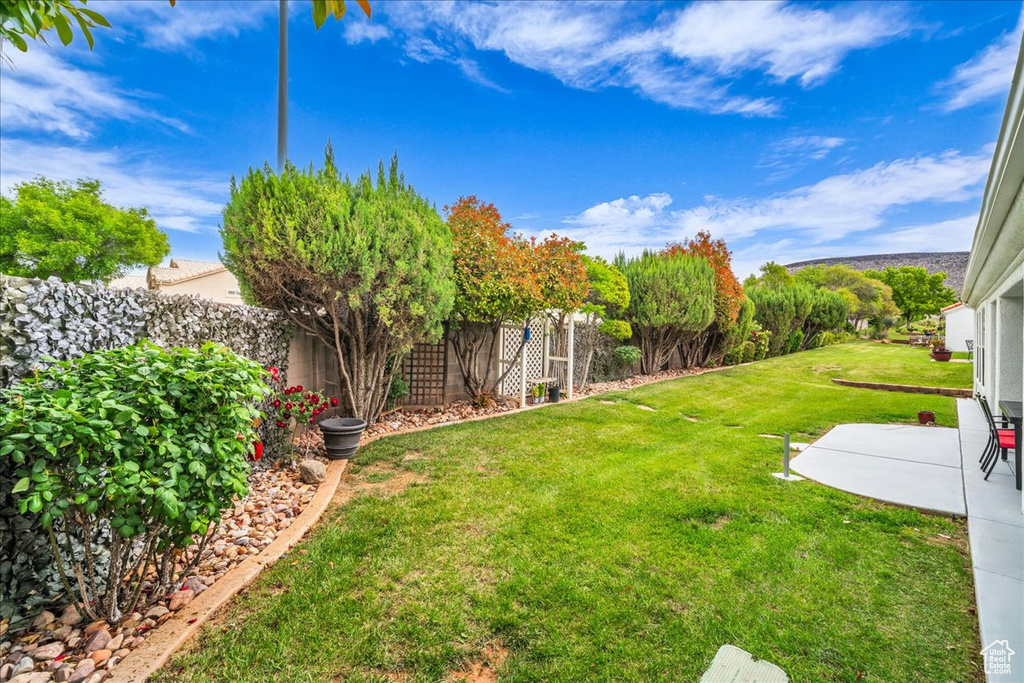 View of yard featuring a fenced backyard and a patio area