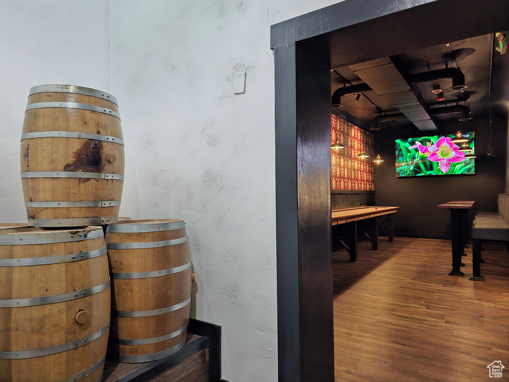 Interior space with wood finished floors and a textured wall