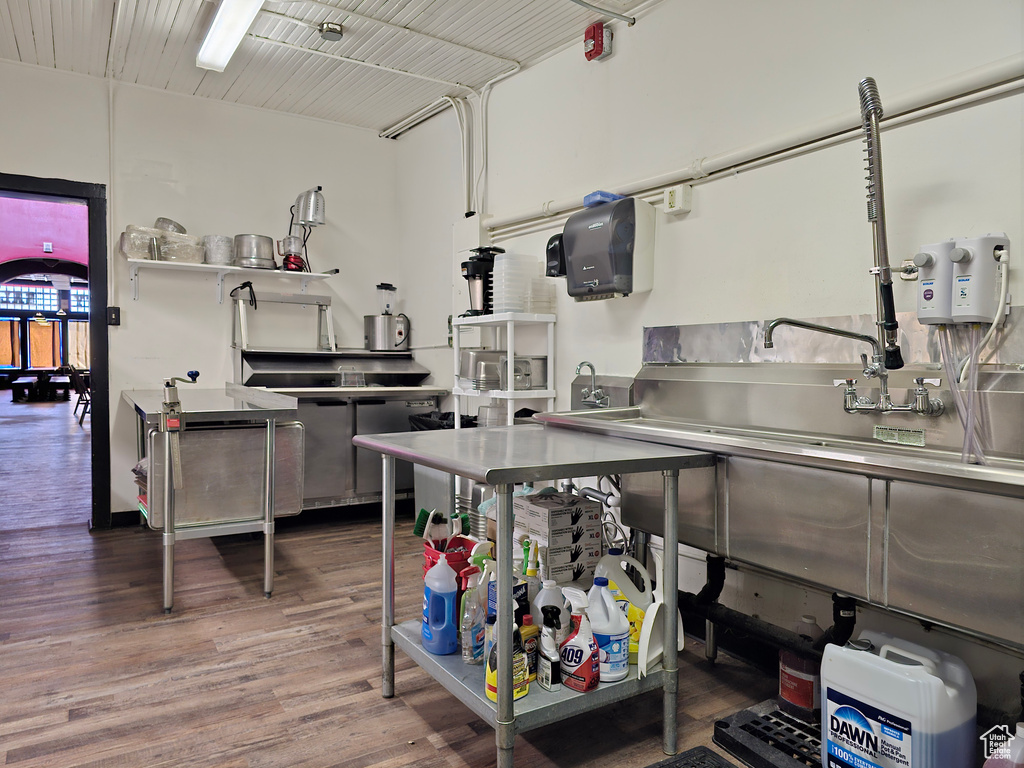 Kitchen featuring stainless steel counters and wood finished floors