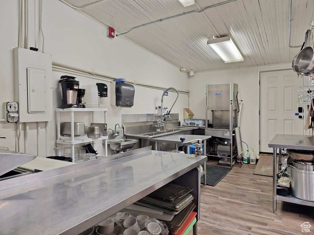 Kitchen featuring stainless steel counters, electric panel, and wood finished floors