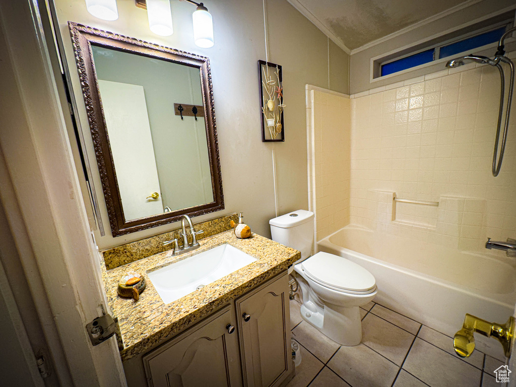 Bathroom featuring toilet,  shower combination, tile patterned floors, vanity, and crown molding