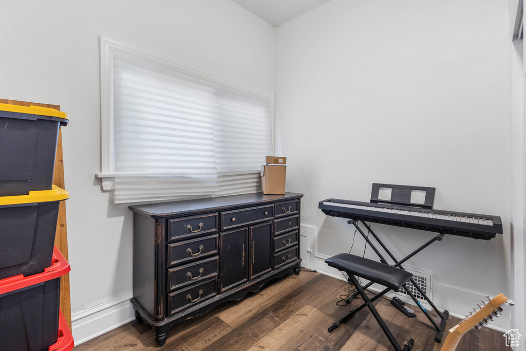 Miscellaneous room with baseboards and dark wood finished floors
