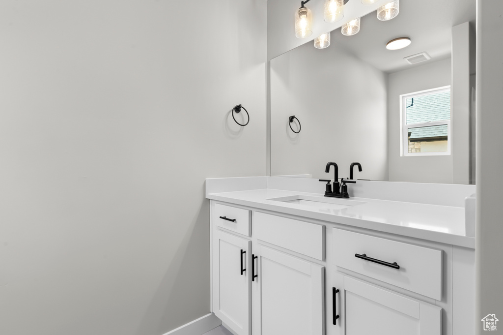 Bathroom featuring vanity and baseboards