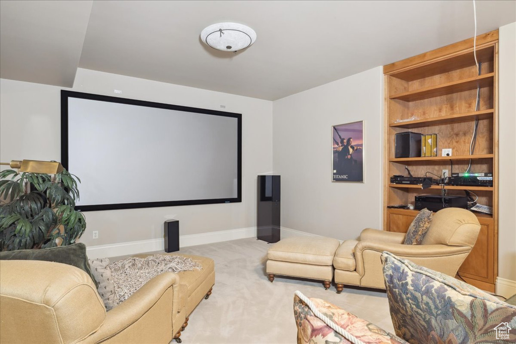Home theater with baseboards, carpet floors, and built in shelves