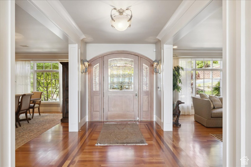 Entrance foyer featuring baseboards and wood finished floors