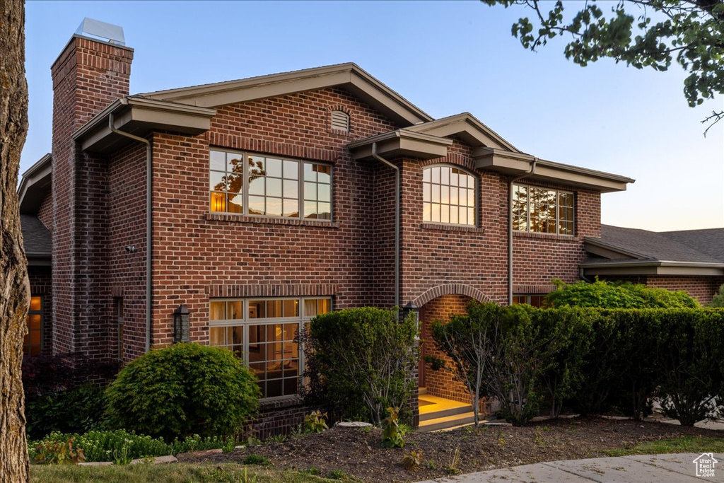 View of home\\\\\\\'s exterior with a chimney and brick siding
