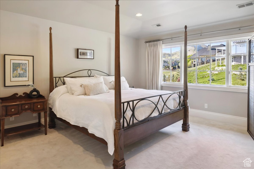 Bedroom featuring visible vents, baseboards, and light carpet