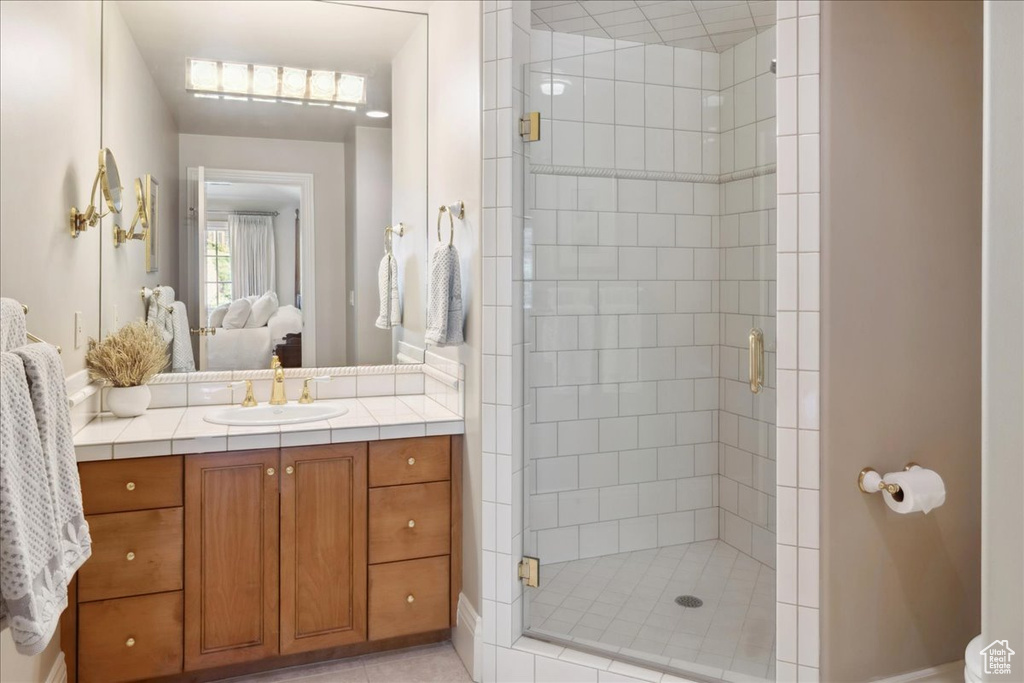 Bathroom with vanity, ensuite bathroom, and a stall shower