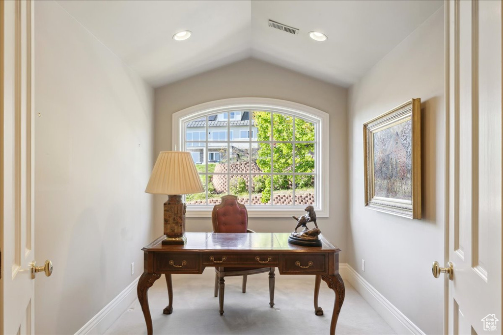 Carpeted office space featuring vaulted ceiling, baseboards, visible vents, and recessed lighting