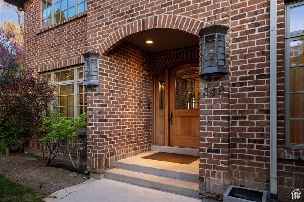 Entrance to property featuring brick siding