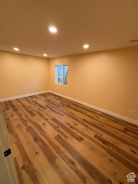 Spare room featuring wood finished floors, recessed lighting, and baseboards