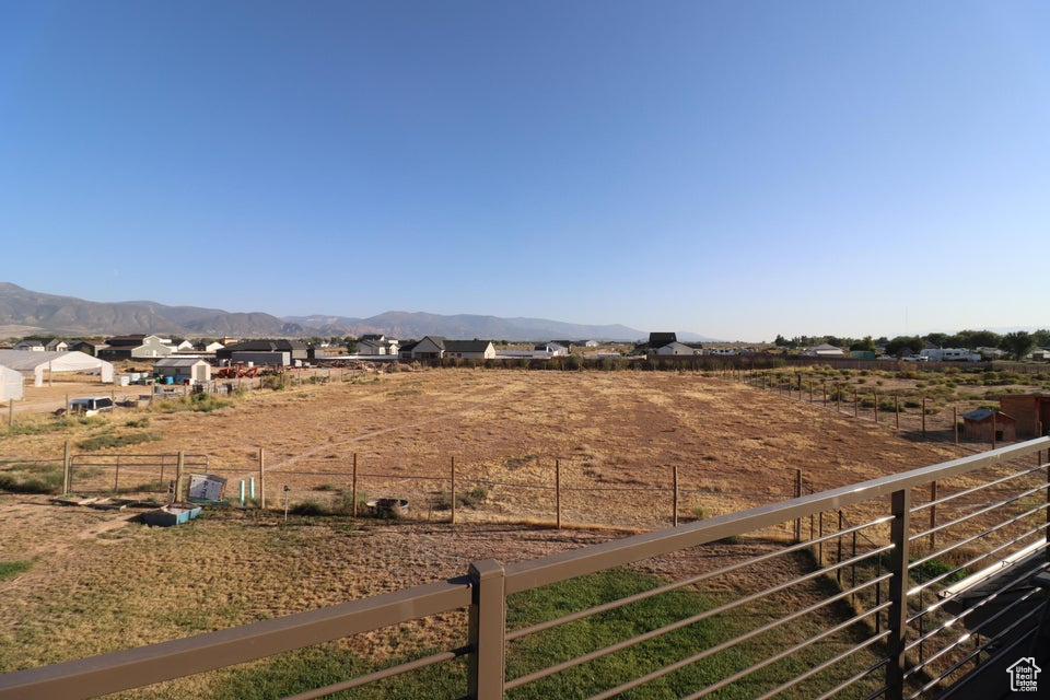 View of yard featuring a mountain view and fence