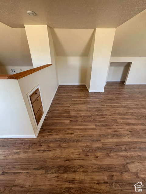 Bonus room with wood finished floors and baseboards