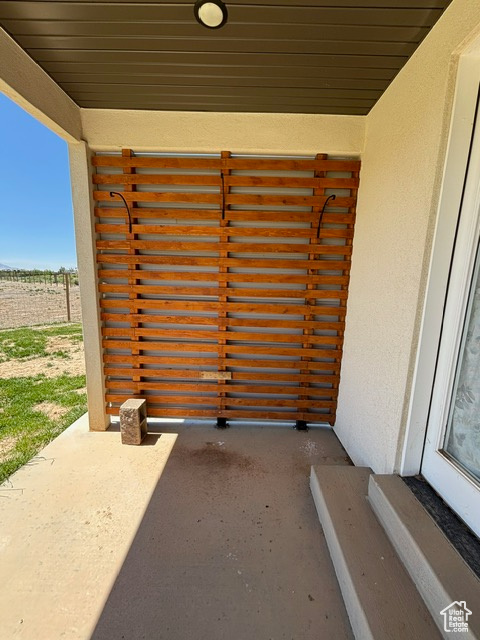 View of exterior entry featuring stucco siding