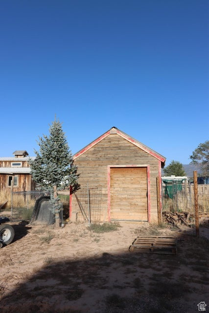 Detached garage featuring fence