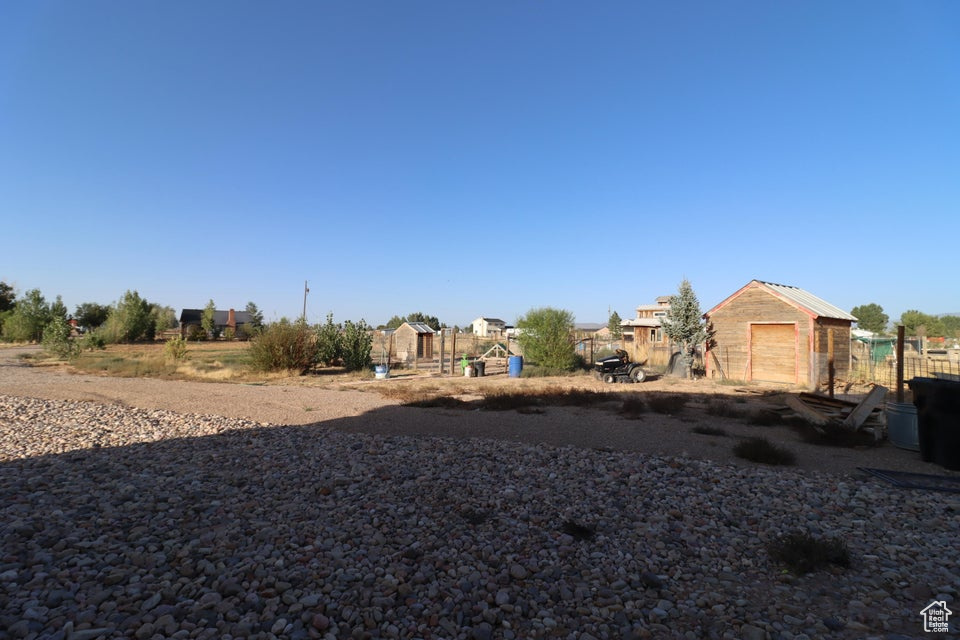 View of yard featuring an outbuilding and fence