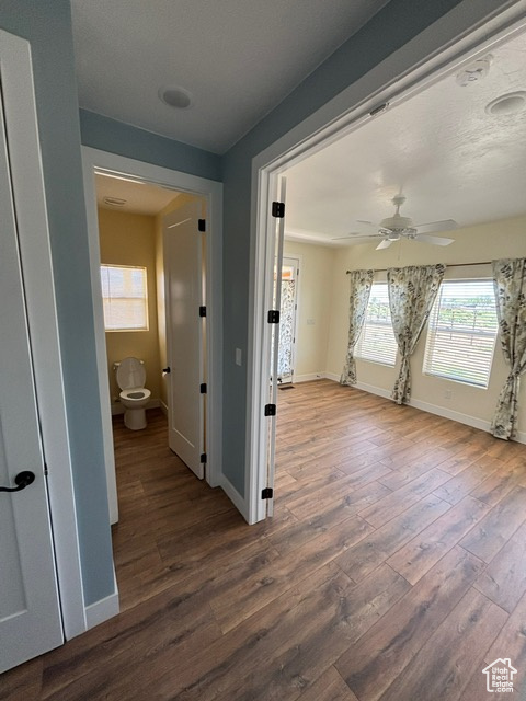 Hallway with wood finished floors and baseboards