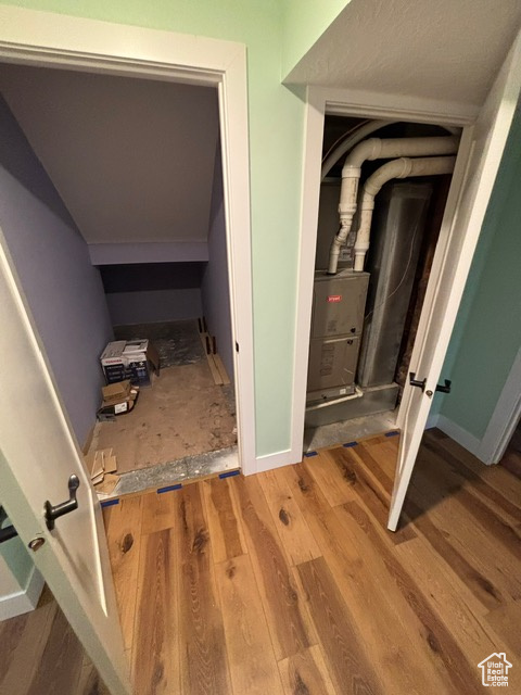 Hall with wood finished floors and baseboards