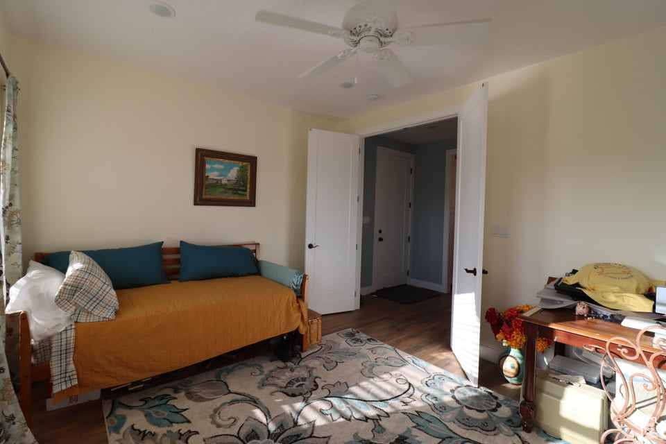 Bedroom with wood finished floors and ceiling fan
