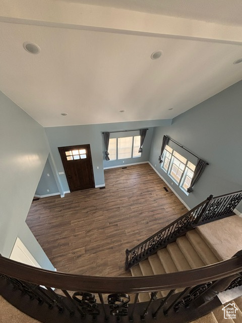 Entryway with baseboards, lofted ceiling, and dark wood-type flooring