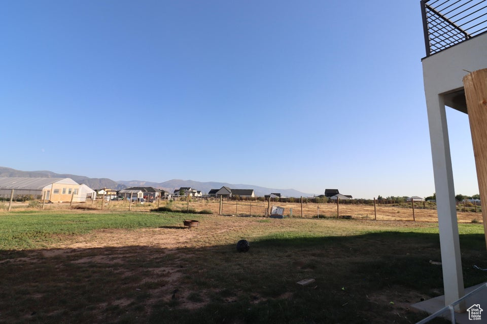 View of yard with fence and a mountain view