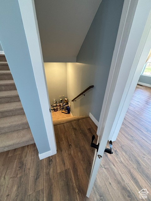 Stairway featuring baseboards and wood finished floors