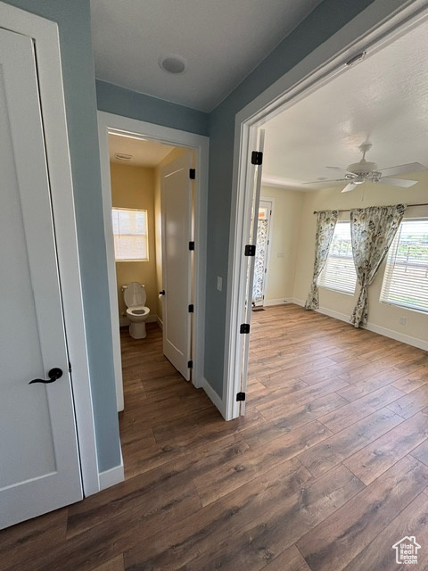 Hall featuring wood finished floors and baseboards