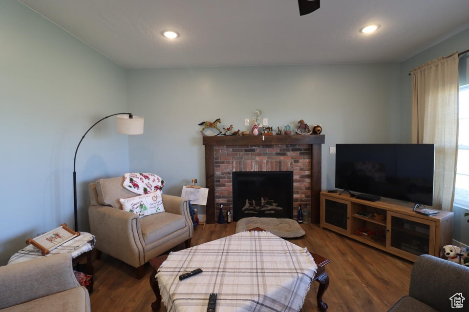 Living area featuring a fireplace, recessed lighting, and wood finished floors