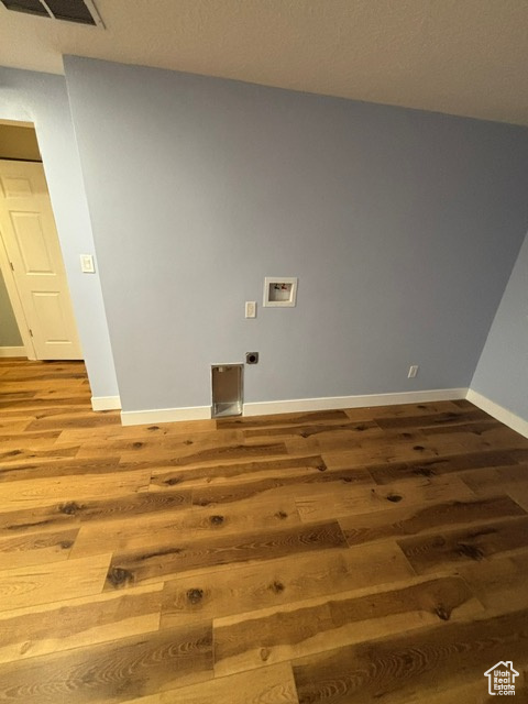 Spare room with wood finished floors and baseboards
