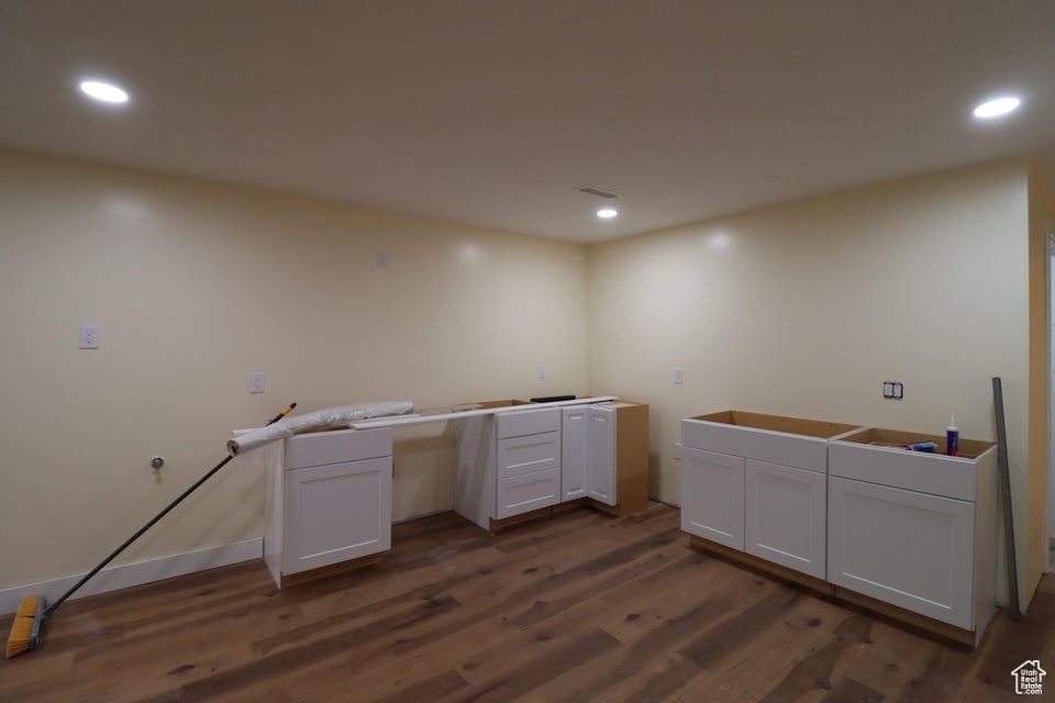 Interior space featuring dark wood-style flooring and recessed lighting